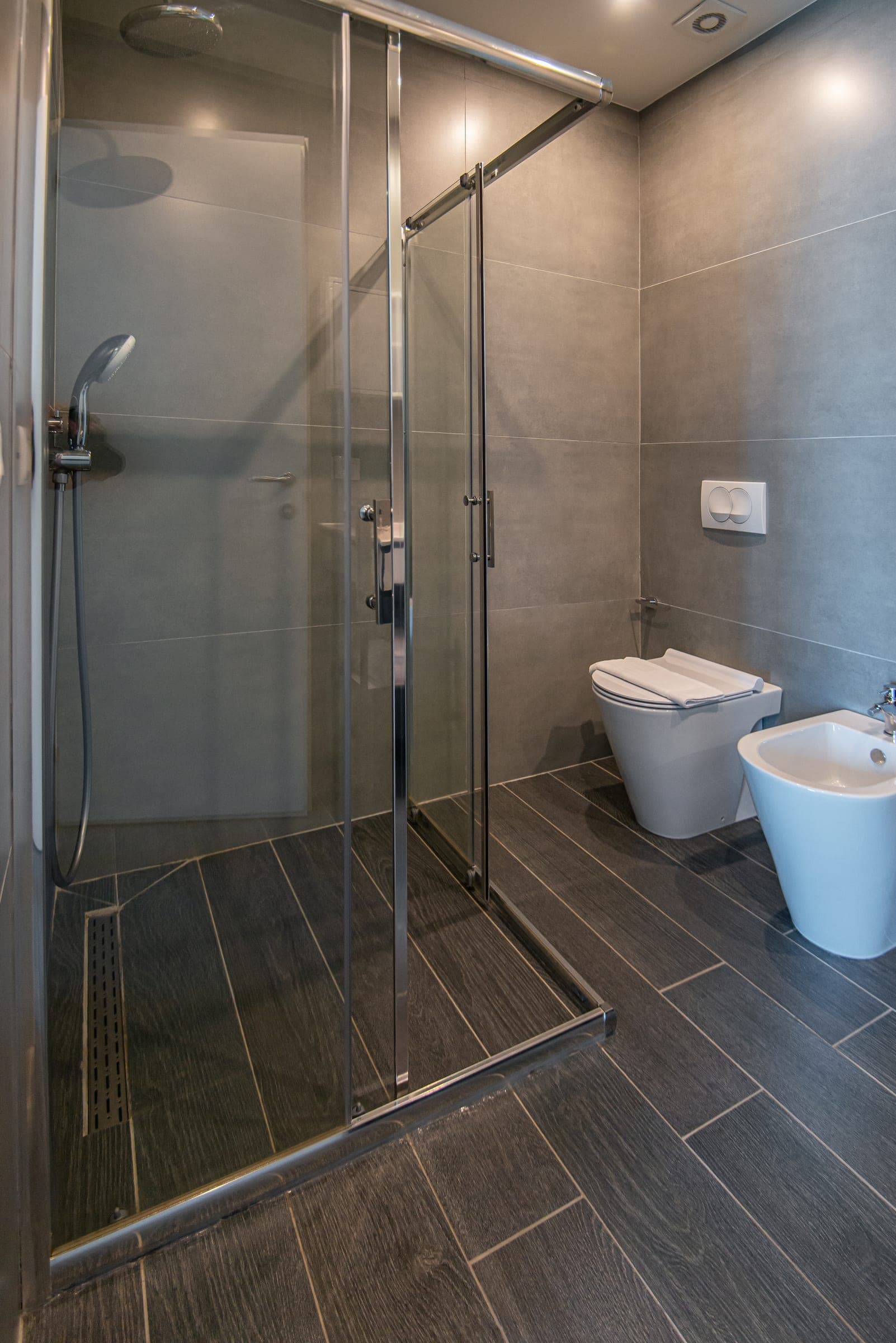 Queen Room bathroom with a walk-in shower and bidet