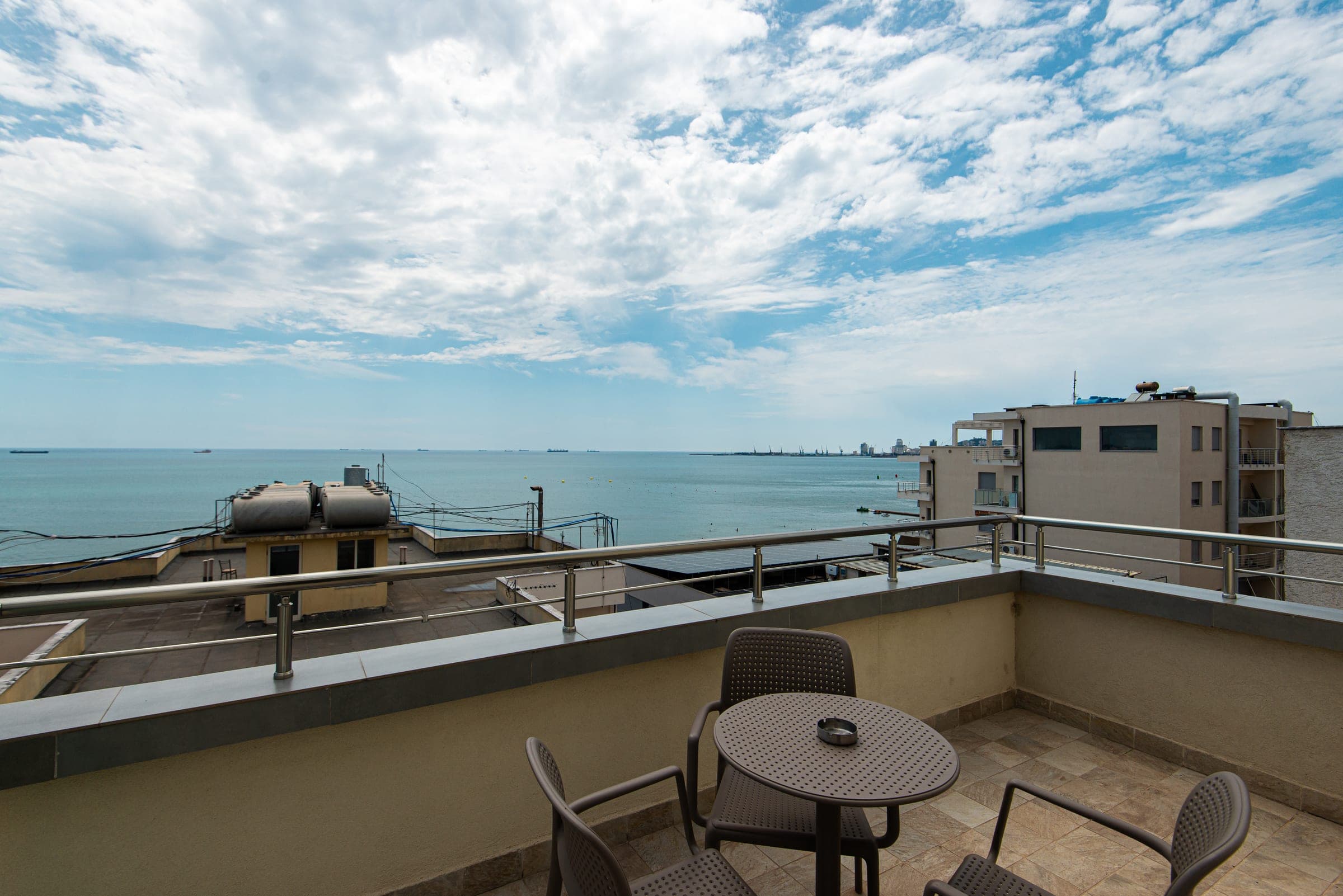 Queen Room terrace with a table, chairs and sea view