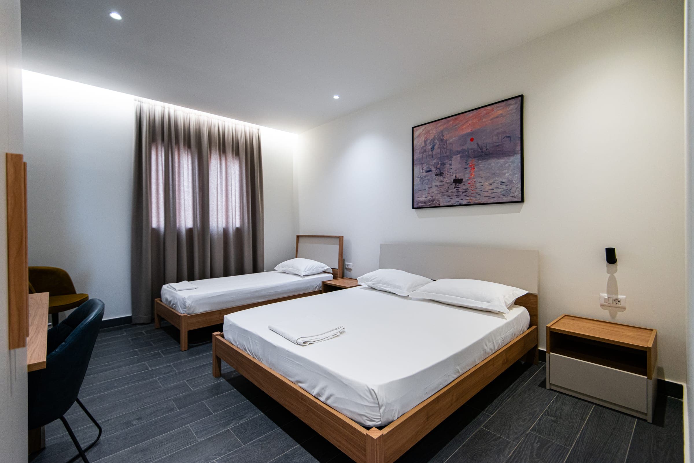 Triple Room with a king bed, single bed and bedside tables